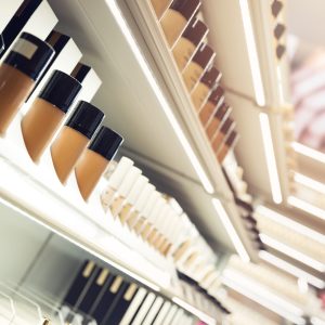 shelves with makeup products in a cosmetics store shelves with makeup products in a cosmetics store
