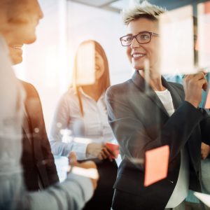Business people planning strategy in office together Business people planning strategy in modern office together